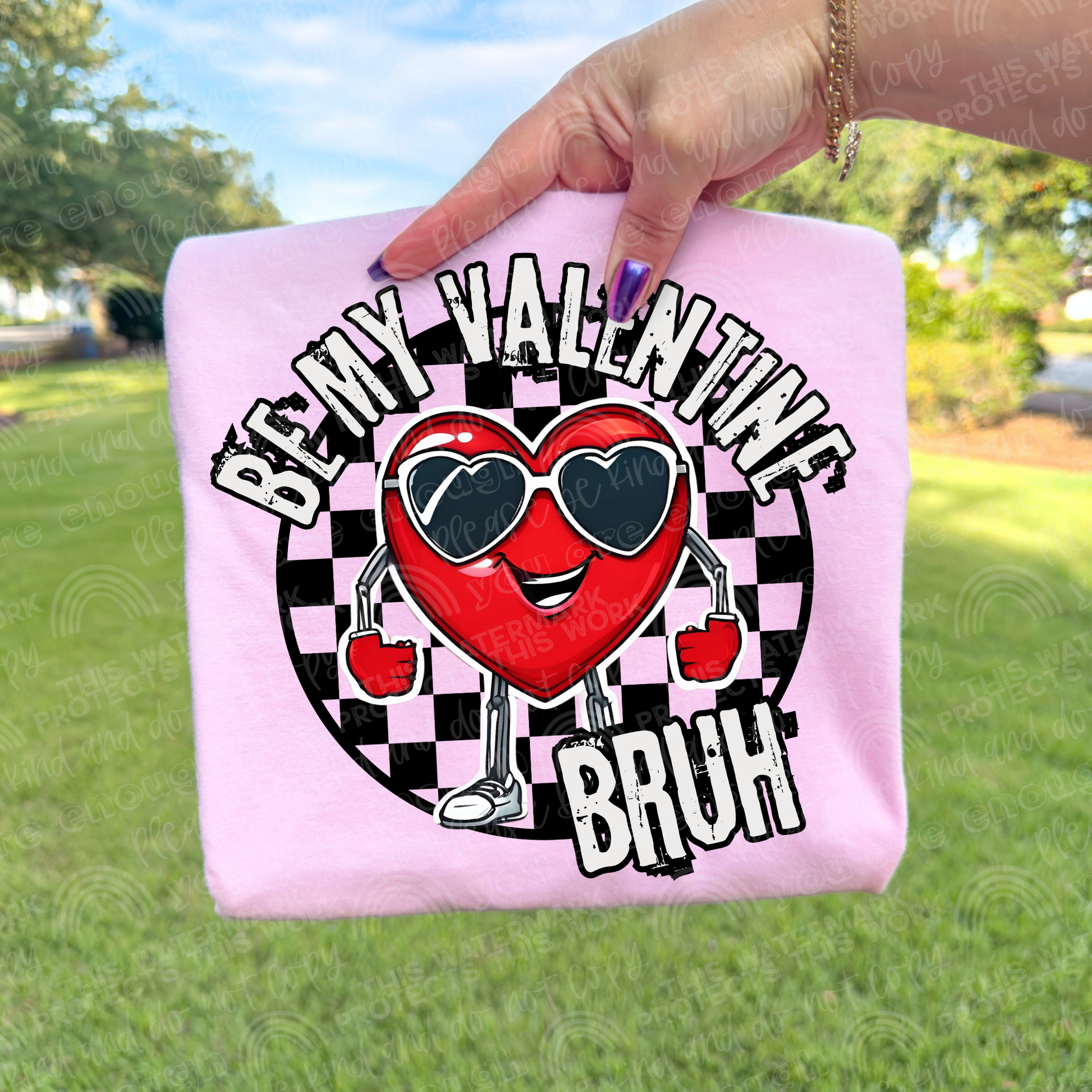 Pink T-shirt with words that read Be my valentine bruh. Has a black checkered background with a heart smiling heart in the middle with arms and legs wearing heart glasses. Perfect for a valentines t-shirt. 