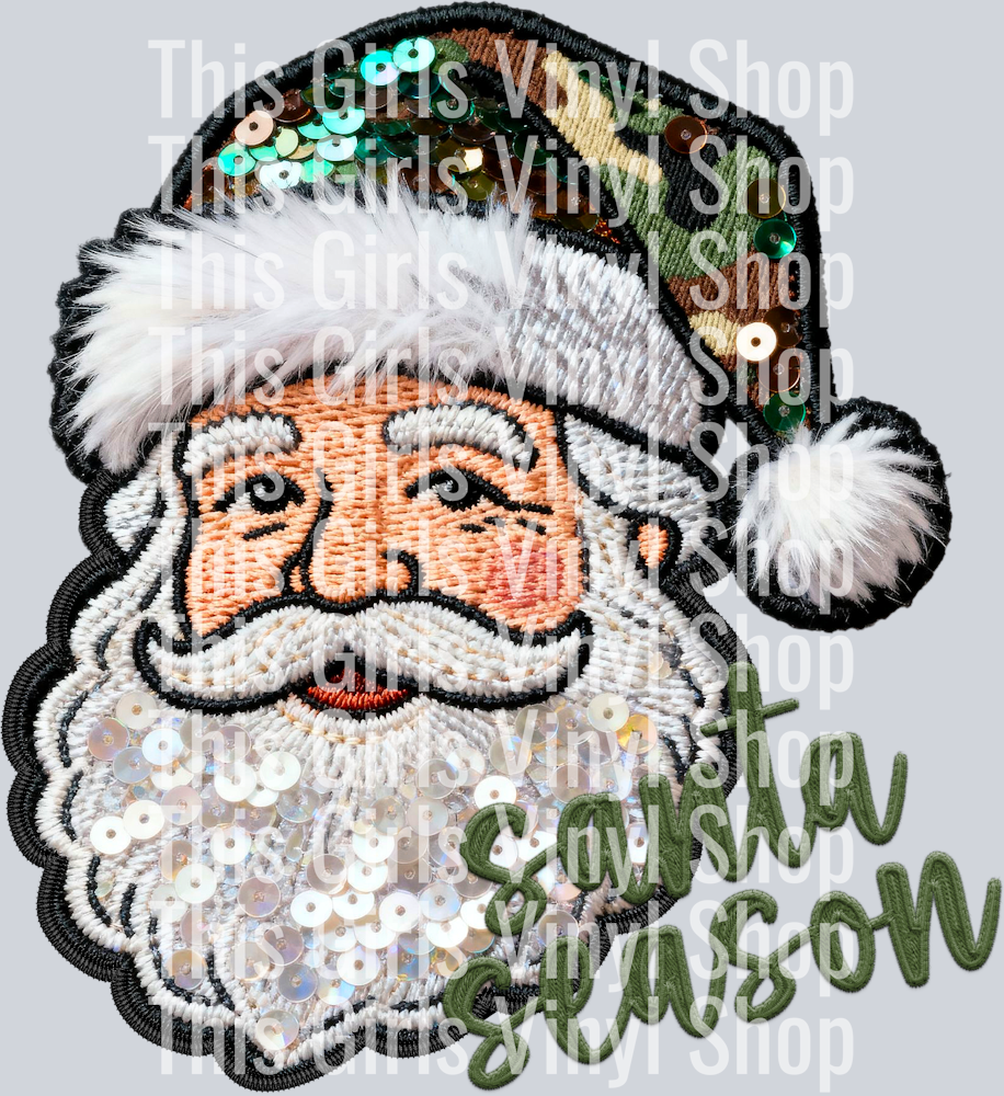 Image of  a stitch sequin Santa with a sequin green camo hat and stitched wording that says Sana Season. Perfect for a Christmas t-shirt