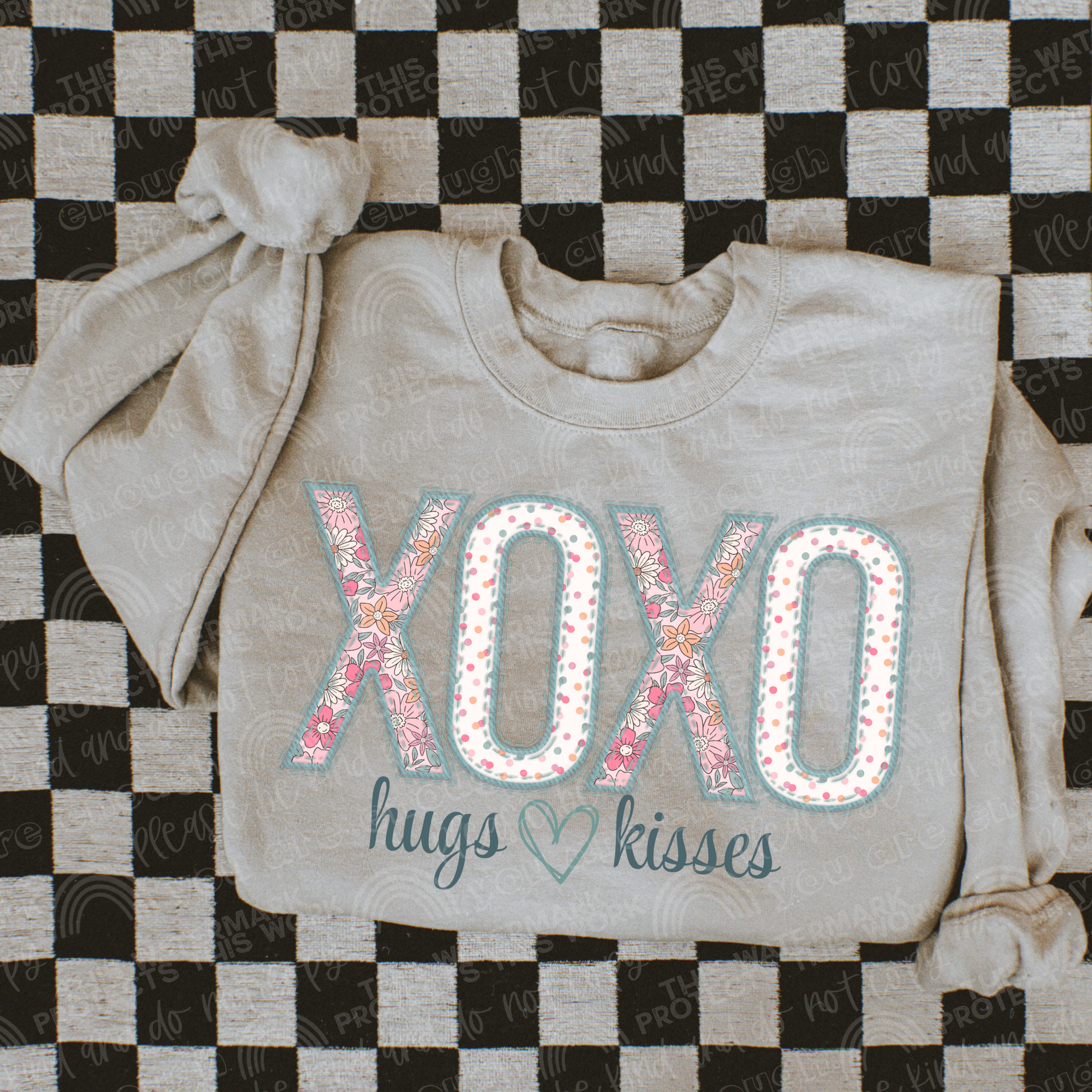 Taupe crewneck with words xoxo and hugs and kisses underneath. The xoxo has a floral and multicolored polka dot print inside of the letters. Perfect for a valentines t-shirt. 